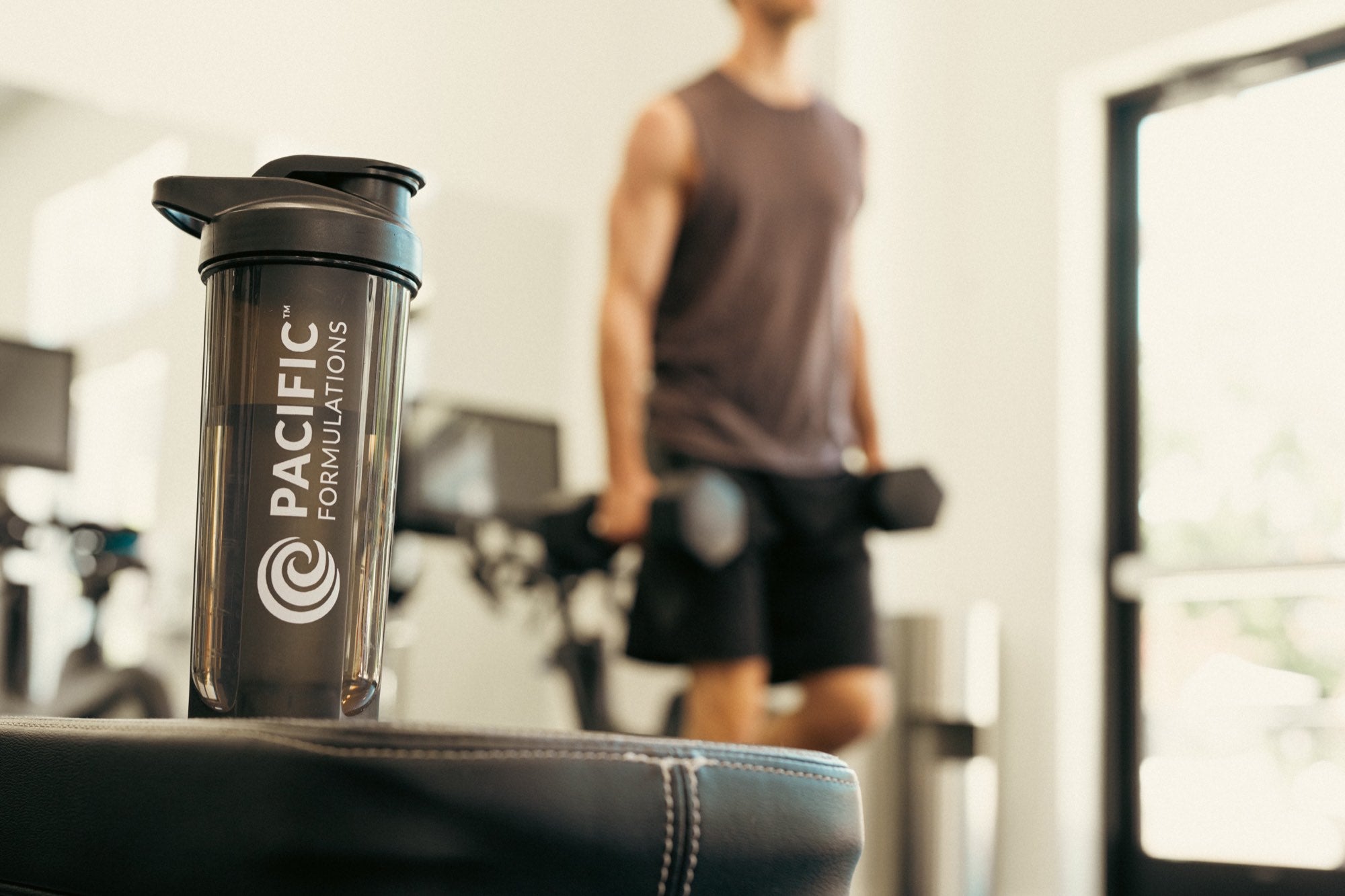 Pacific Formulations shaker bottle in a home gym